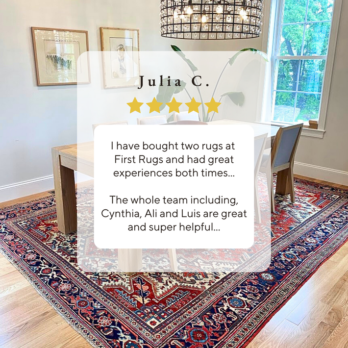 A dining room with a rug and a table and chairs.