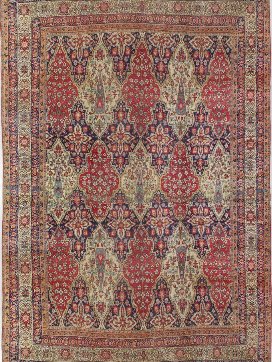An antique rug with a floral pattern on it