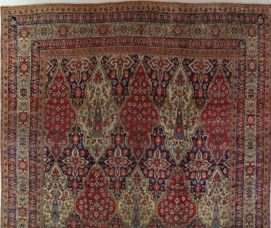 An antique rug with a floral pattern on it