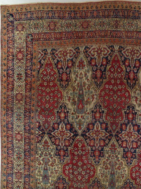 An antique rug with a floral pattern on it
