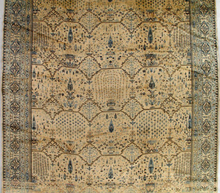 A rug with a floral pattern is hanging on a wall