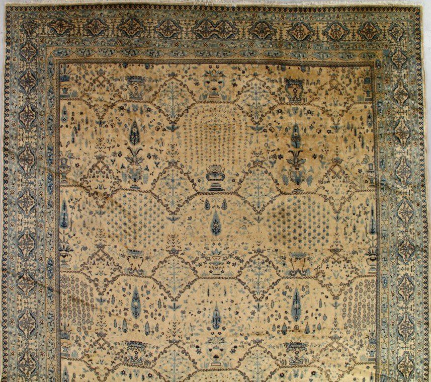 A rug with a floral pattern is hanging on a wall