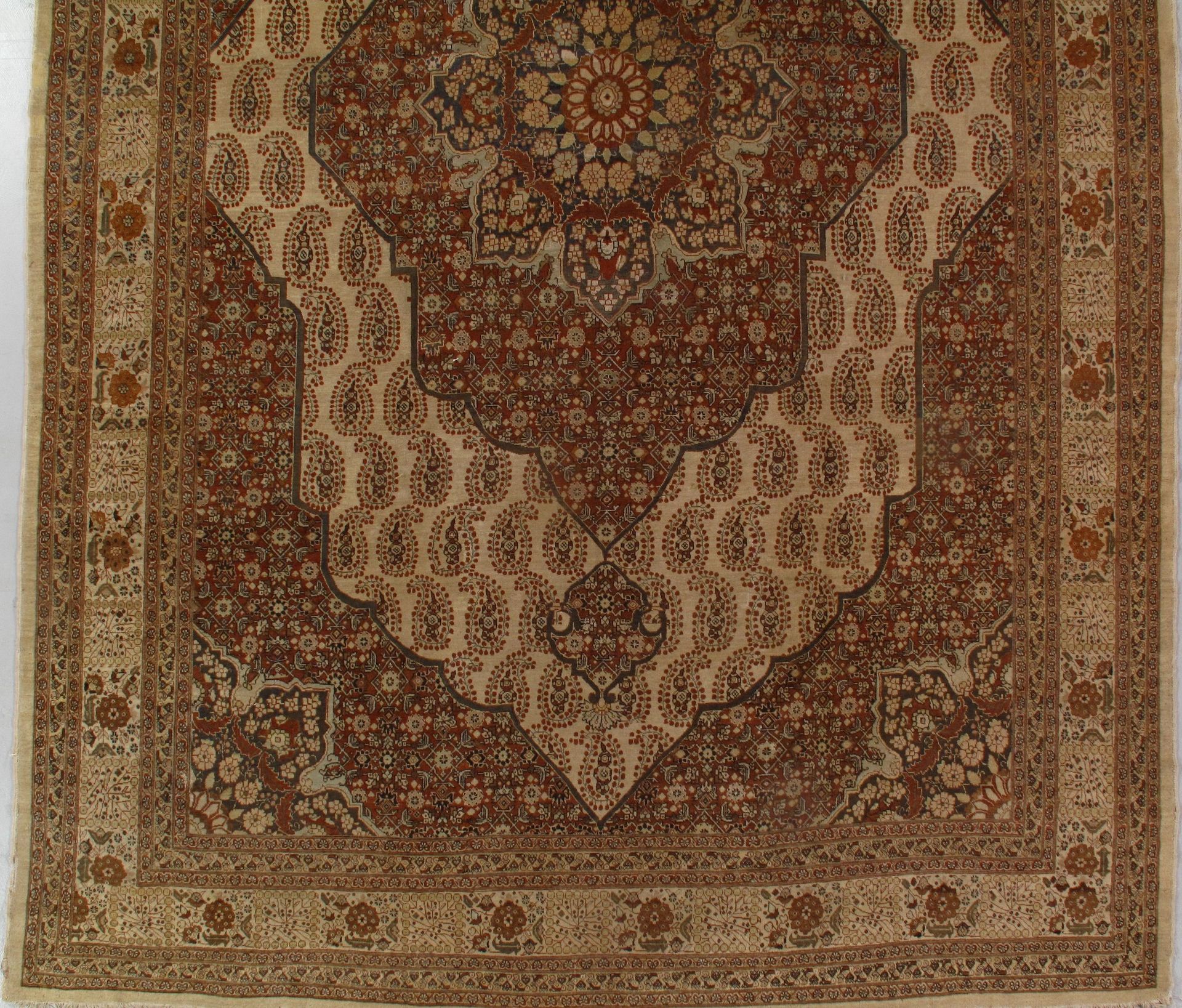 A brown and white rug with a floral pattern on it