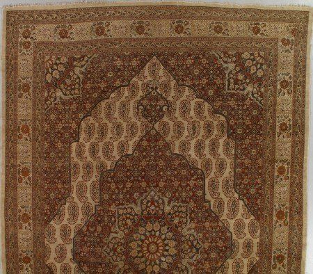 A brown and white rug with a floral pattern on it