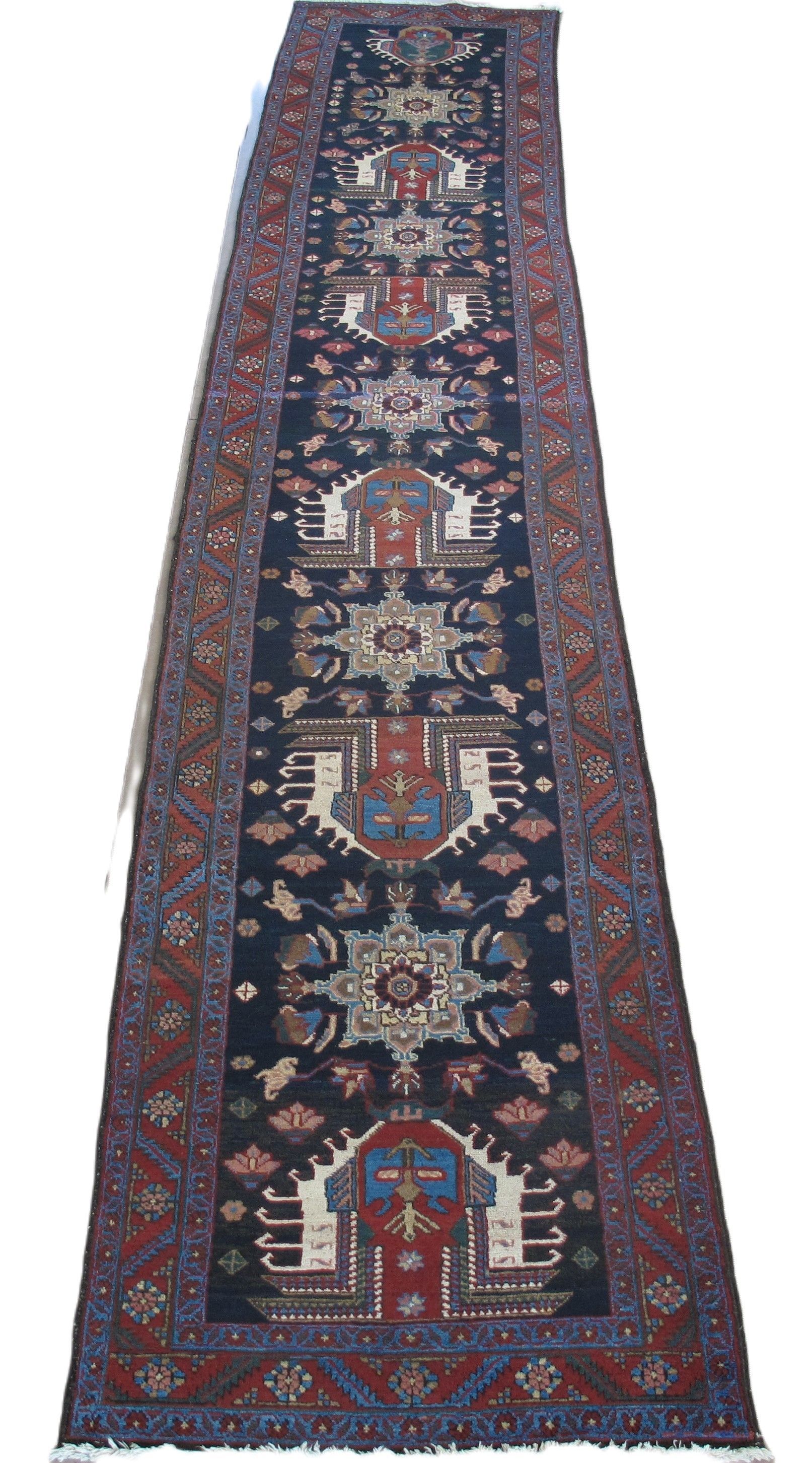 Dark blue runner rug with red and beige geometric patterns.