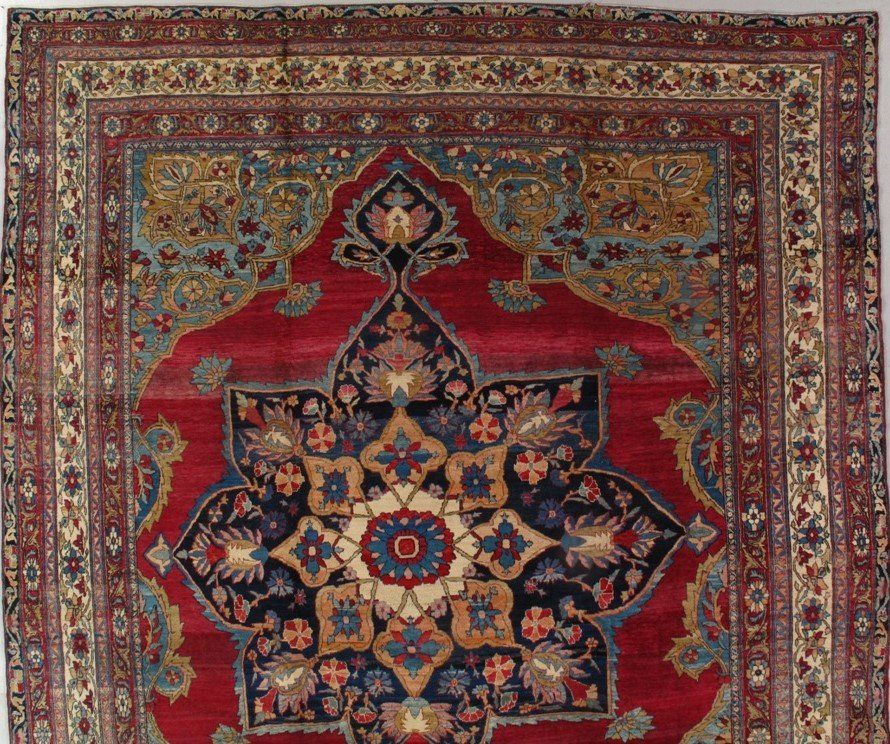 A red rug with a floral design on it