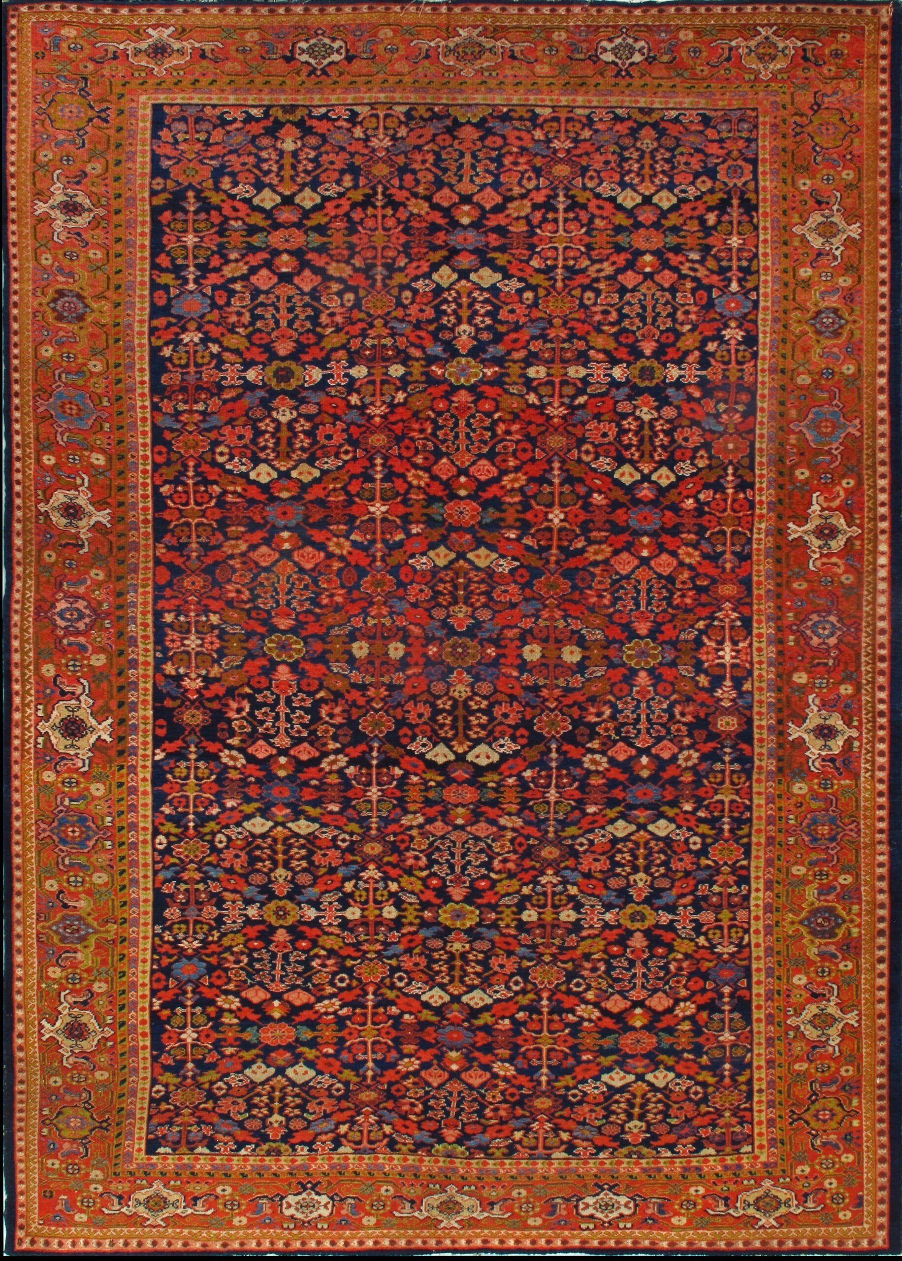A red and blue rug with a floral pattern on it