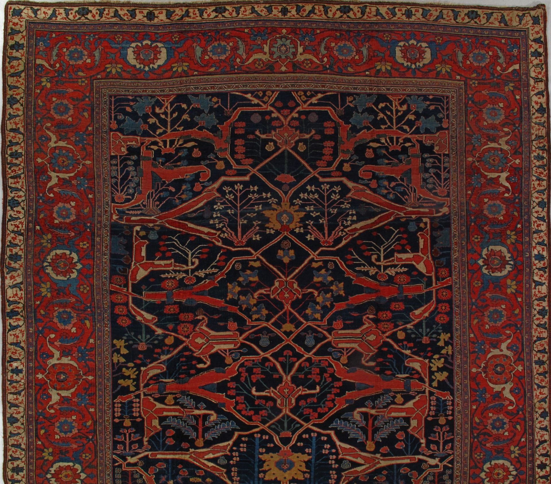 A rug with a blue background and red border