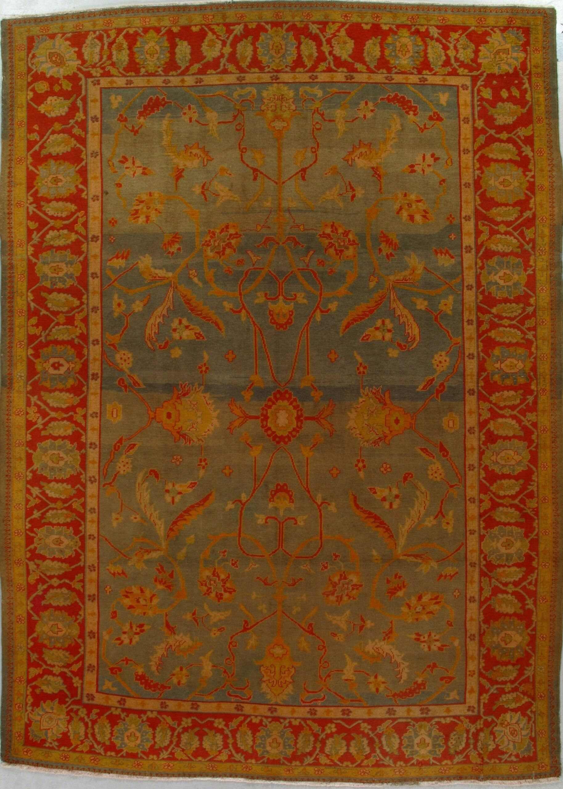 A rug with a red border and a floral pattern on it.