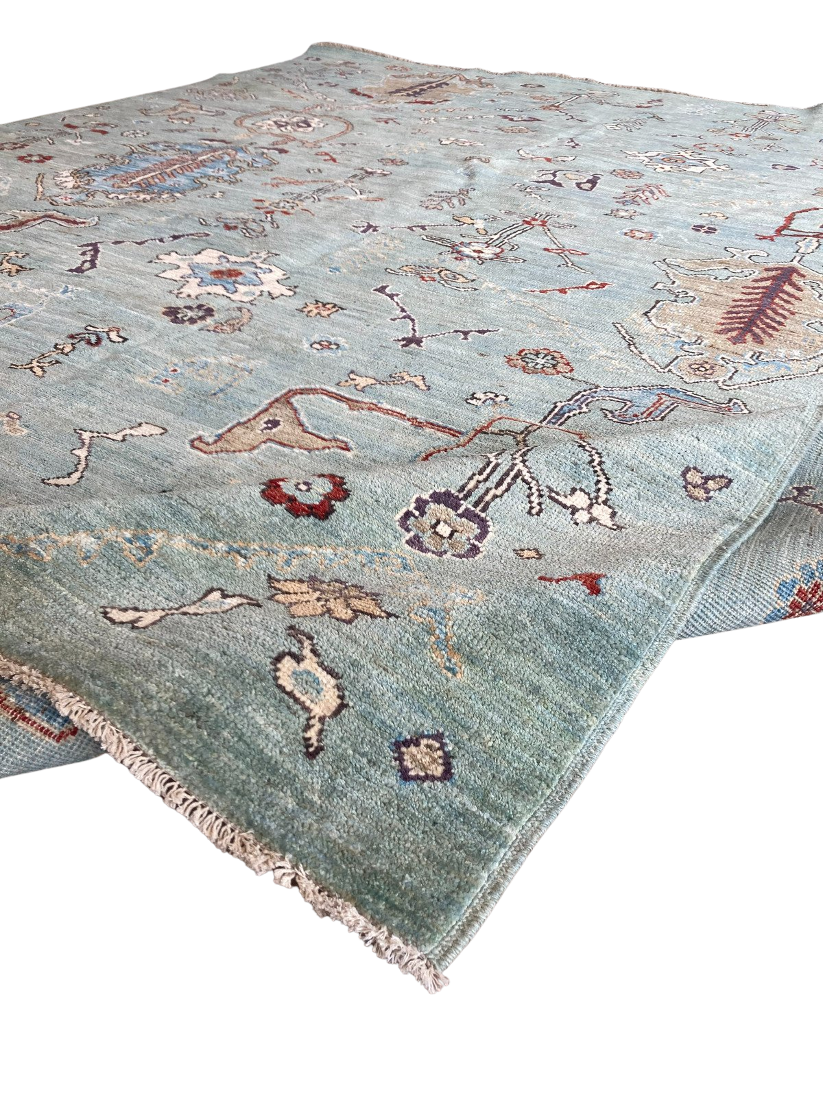 A blue rug with a pattern on it is on a white background.