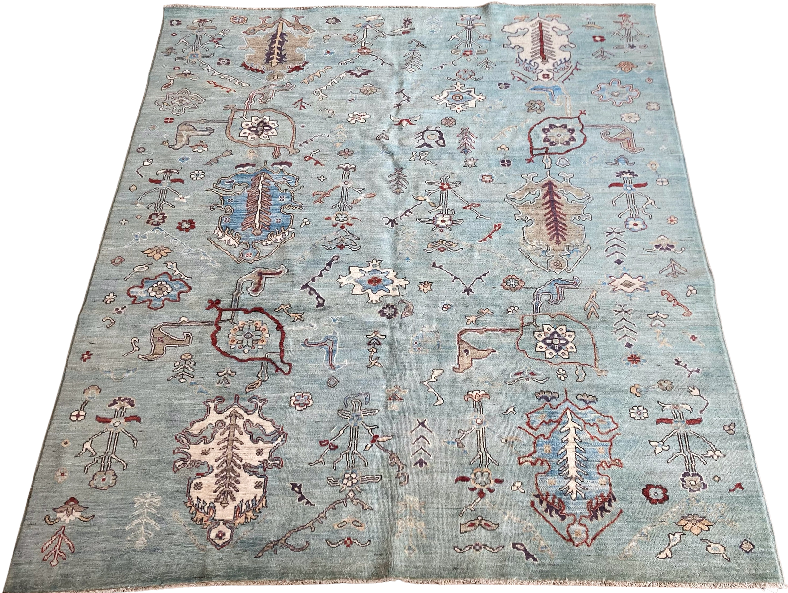 A blue rug with a pattern on it is on a white background.