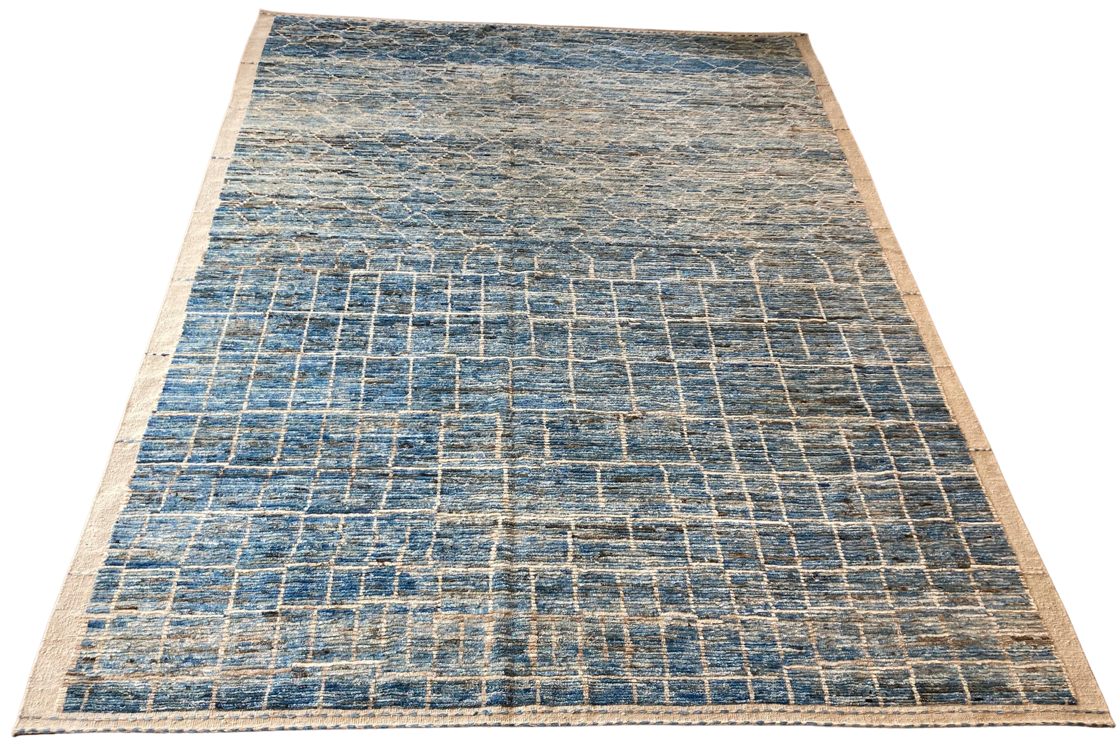 A blue and white rug with a brick pattern on a white background.
