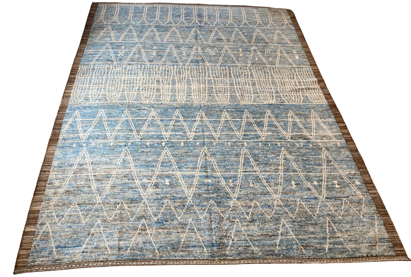 A blue and white rug with a geometric pattern on a white background.