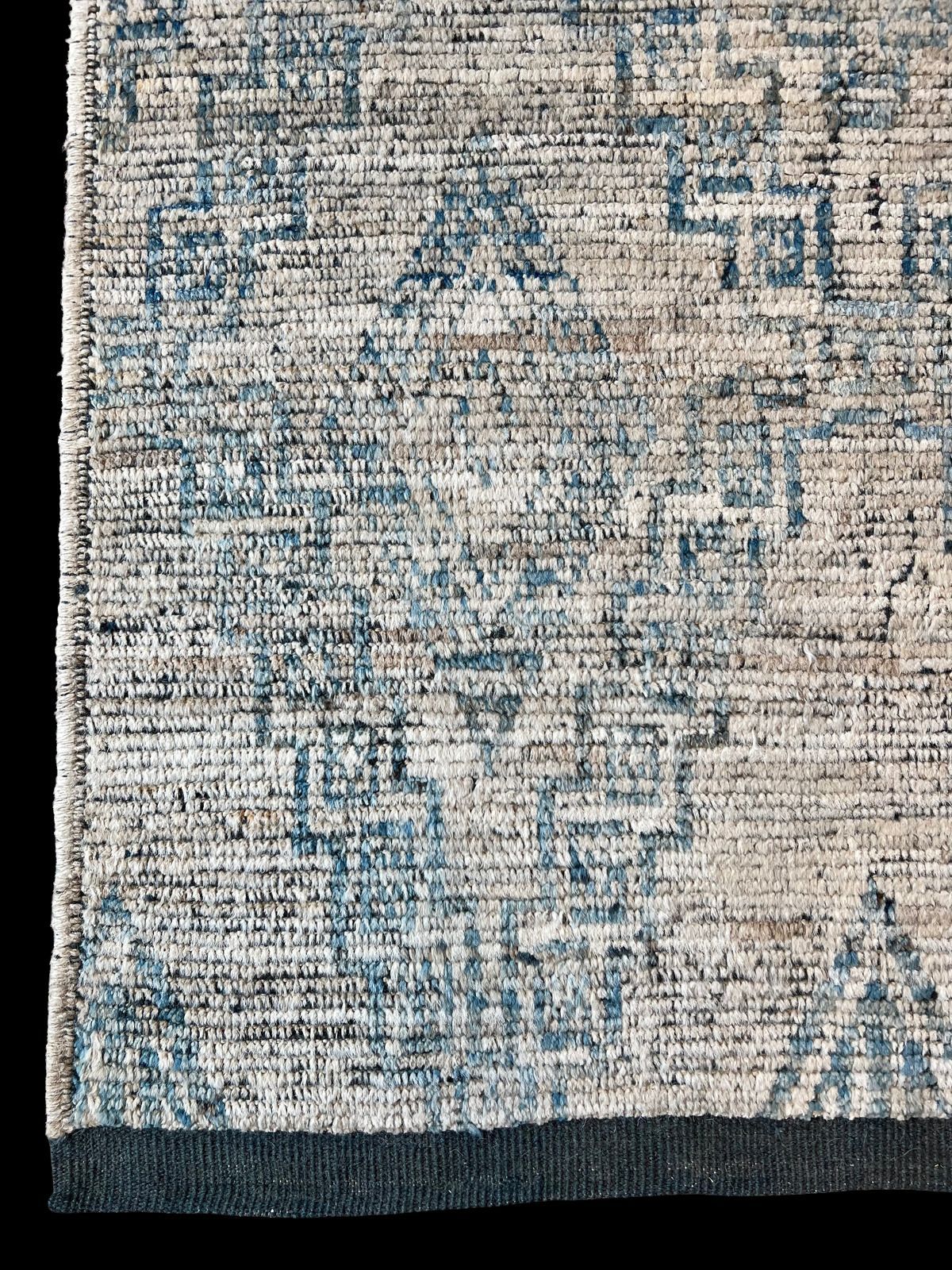 A rug with a pattern on it is sitting on a black surface.