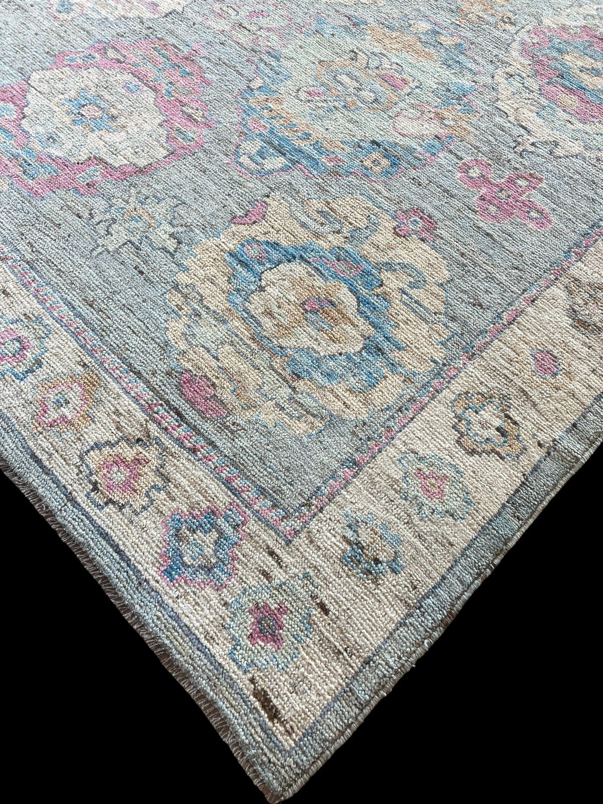 A rug with a floral pattern on it is on a black background.