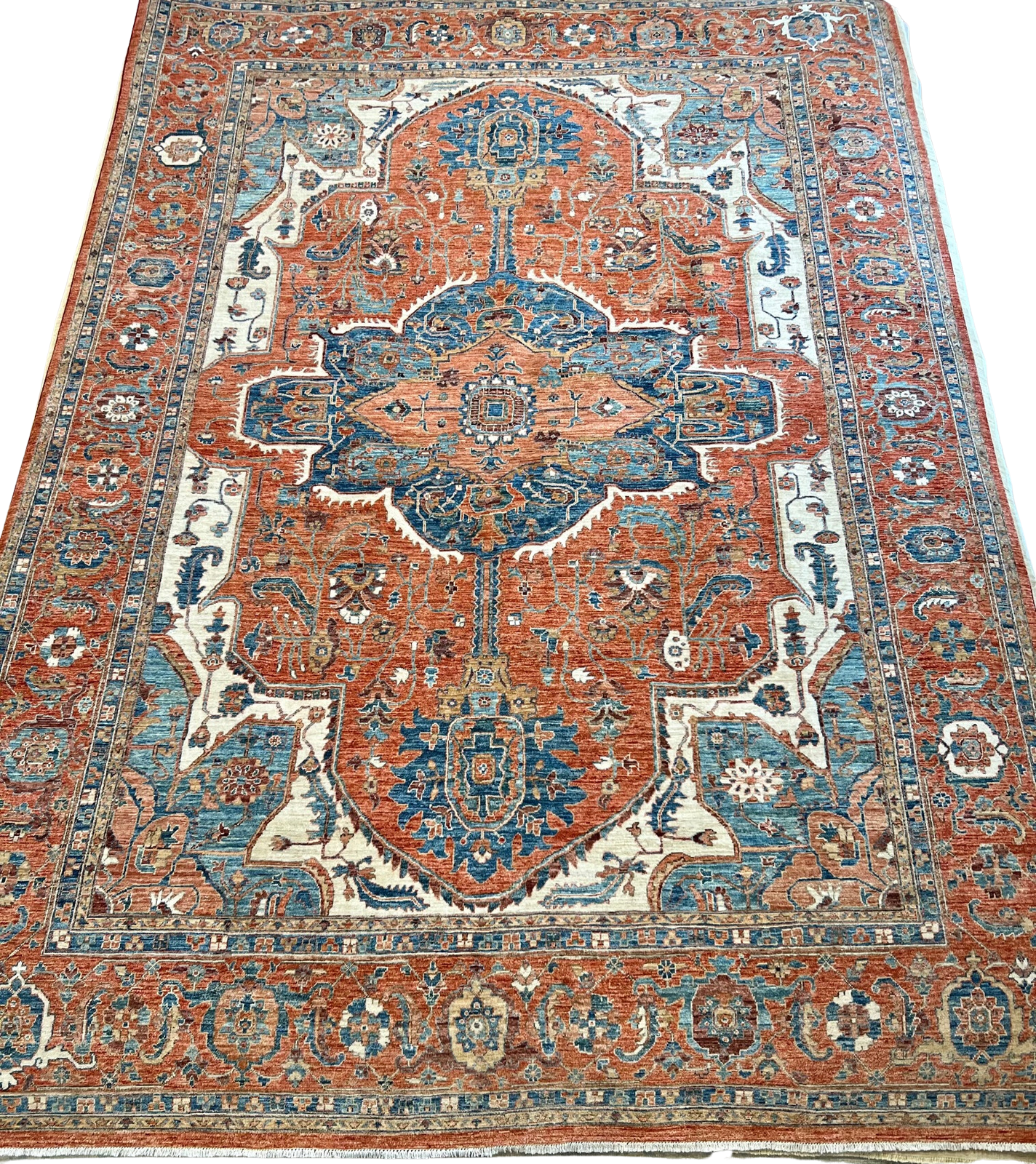 A close up of a rug with a pattern on it on a white background.