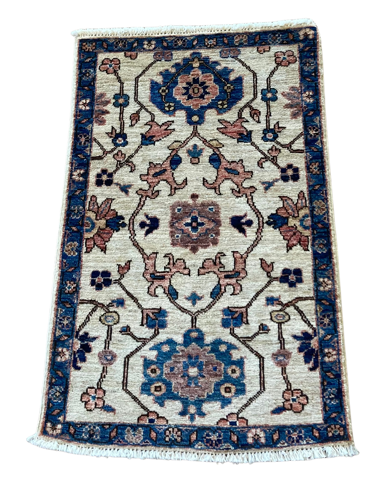 A rug with a floral pattern on it is on a white background.