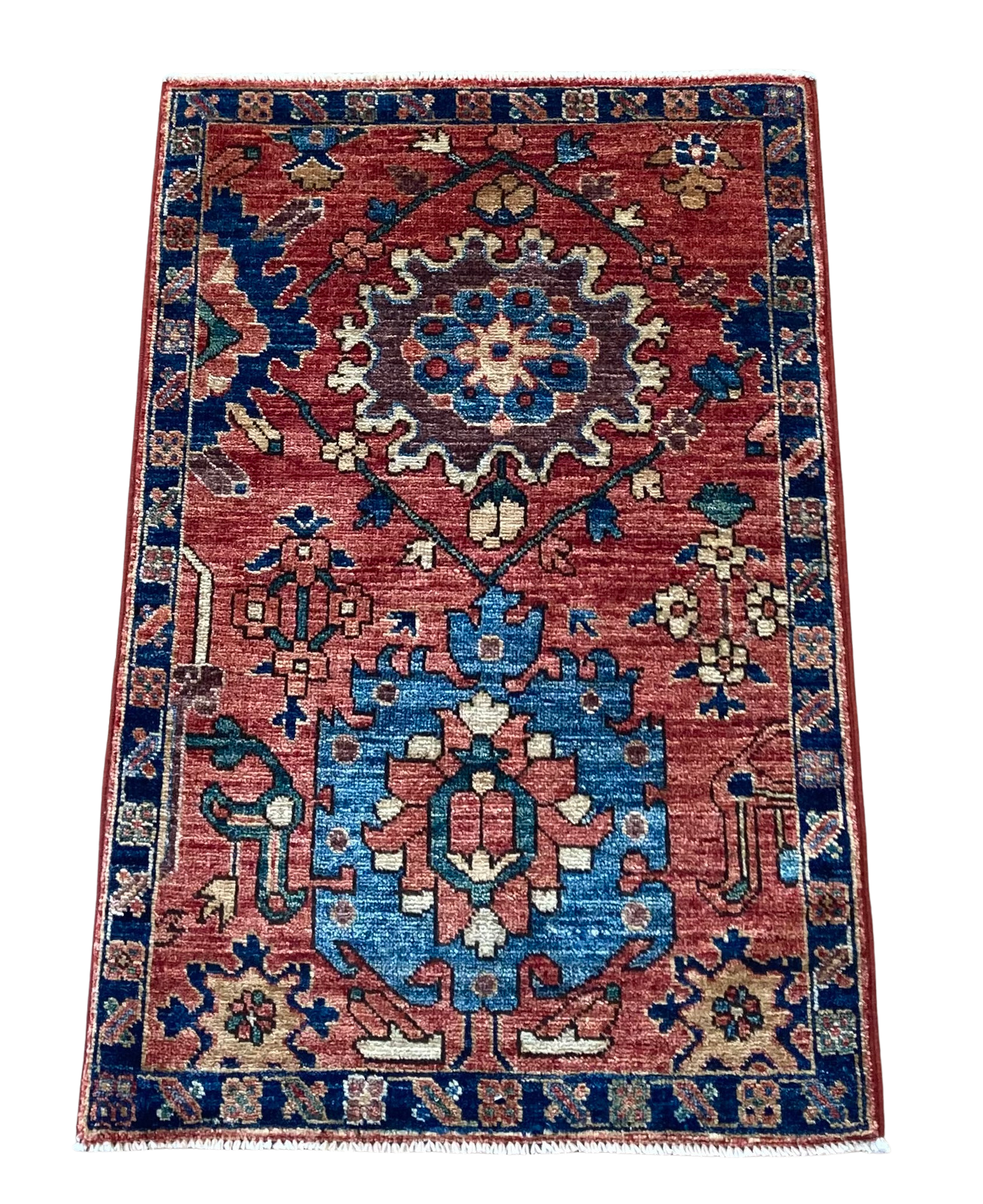 A red and blue rug with a floral pattern on it