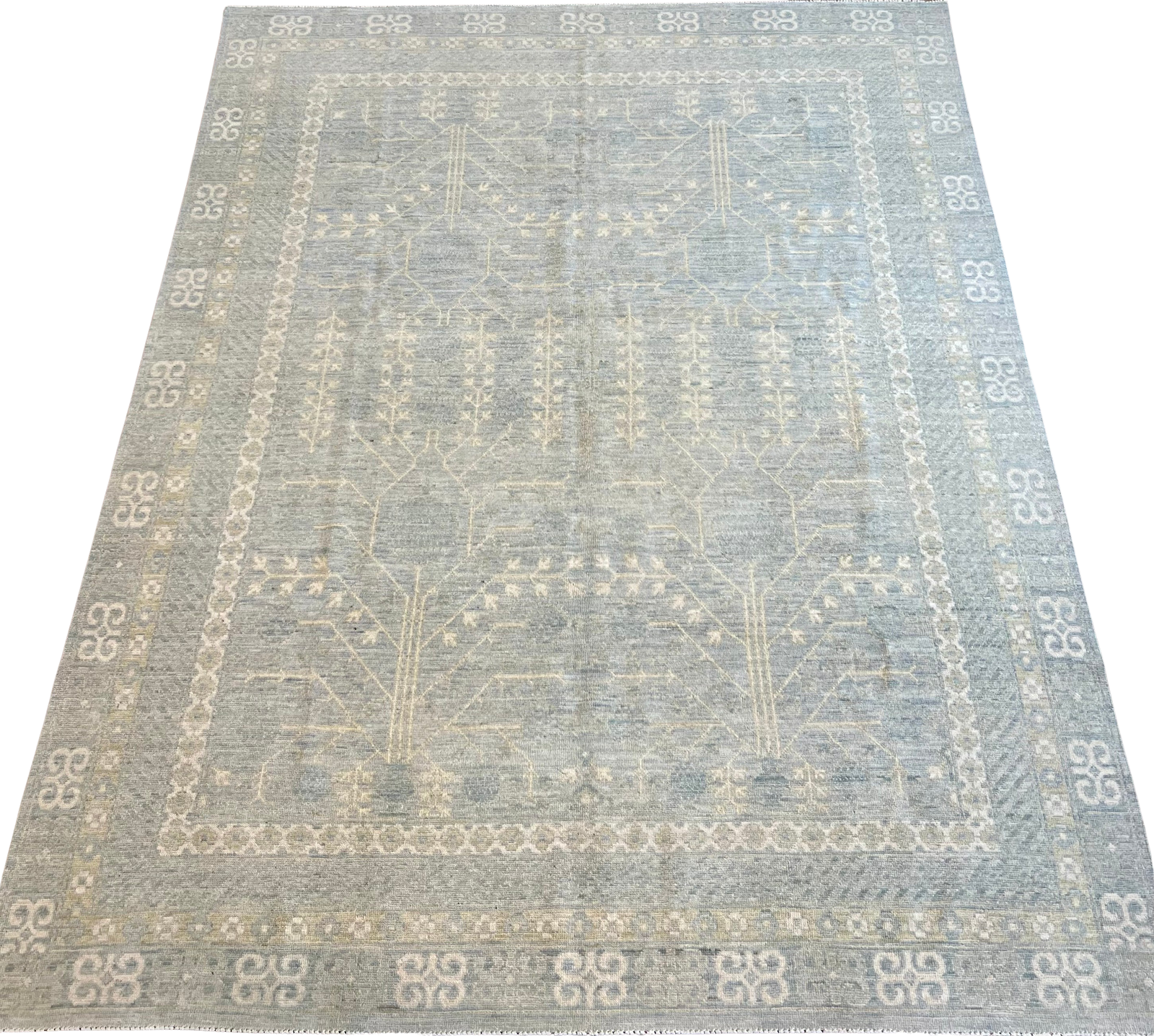 A rug with a pattern on it is sitting on a white surface.
