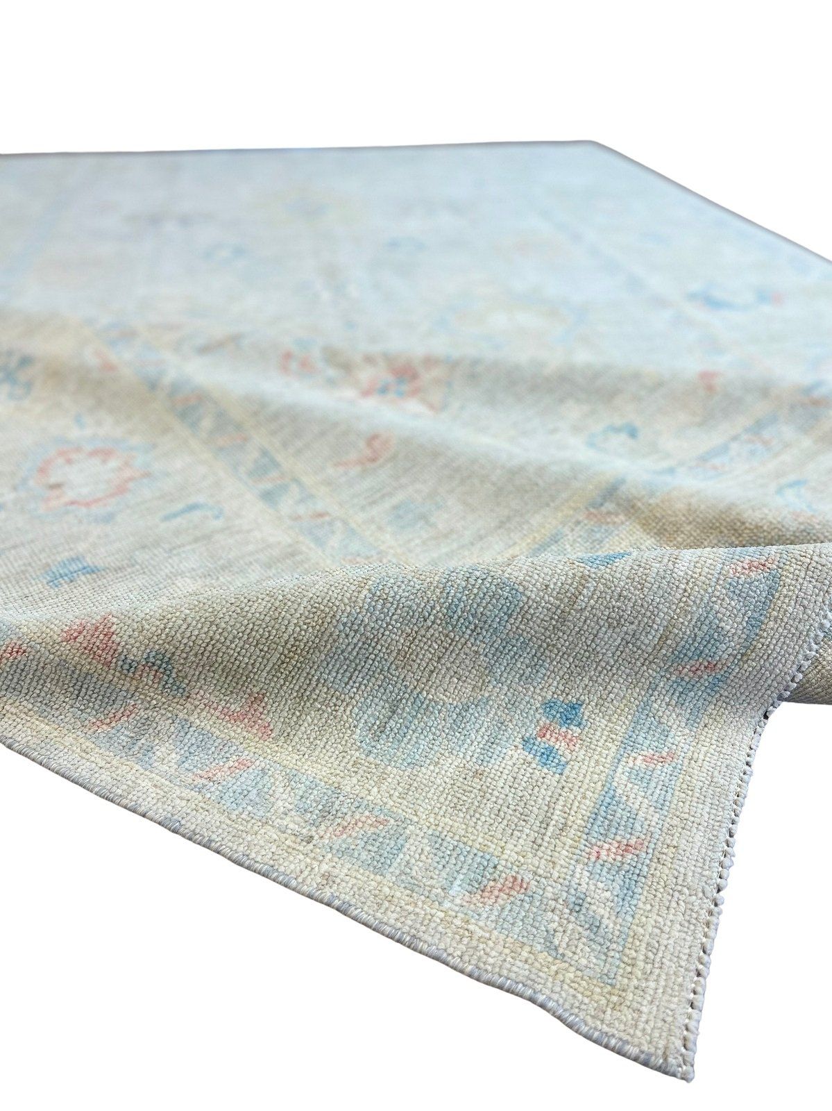 A rug with a floral pattern on it is on a white background