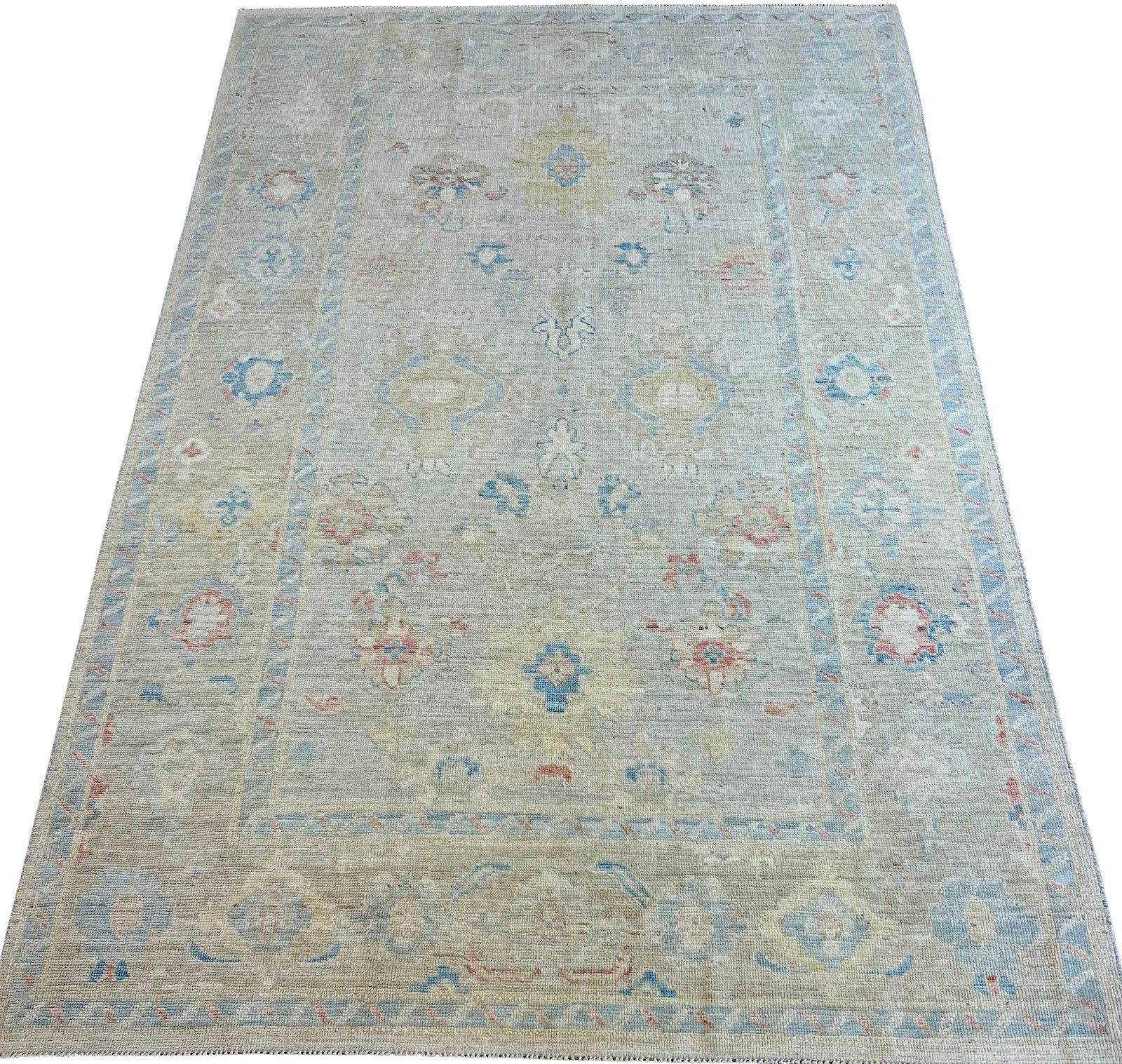 A rug with a floral pattern on it is on a white background