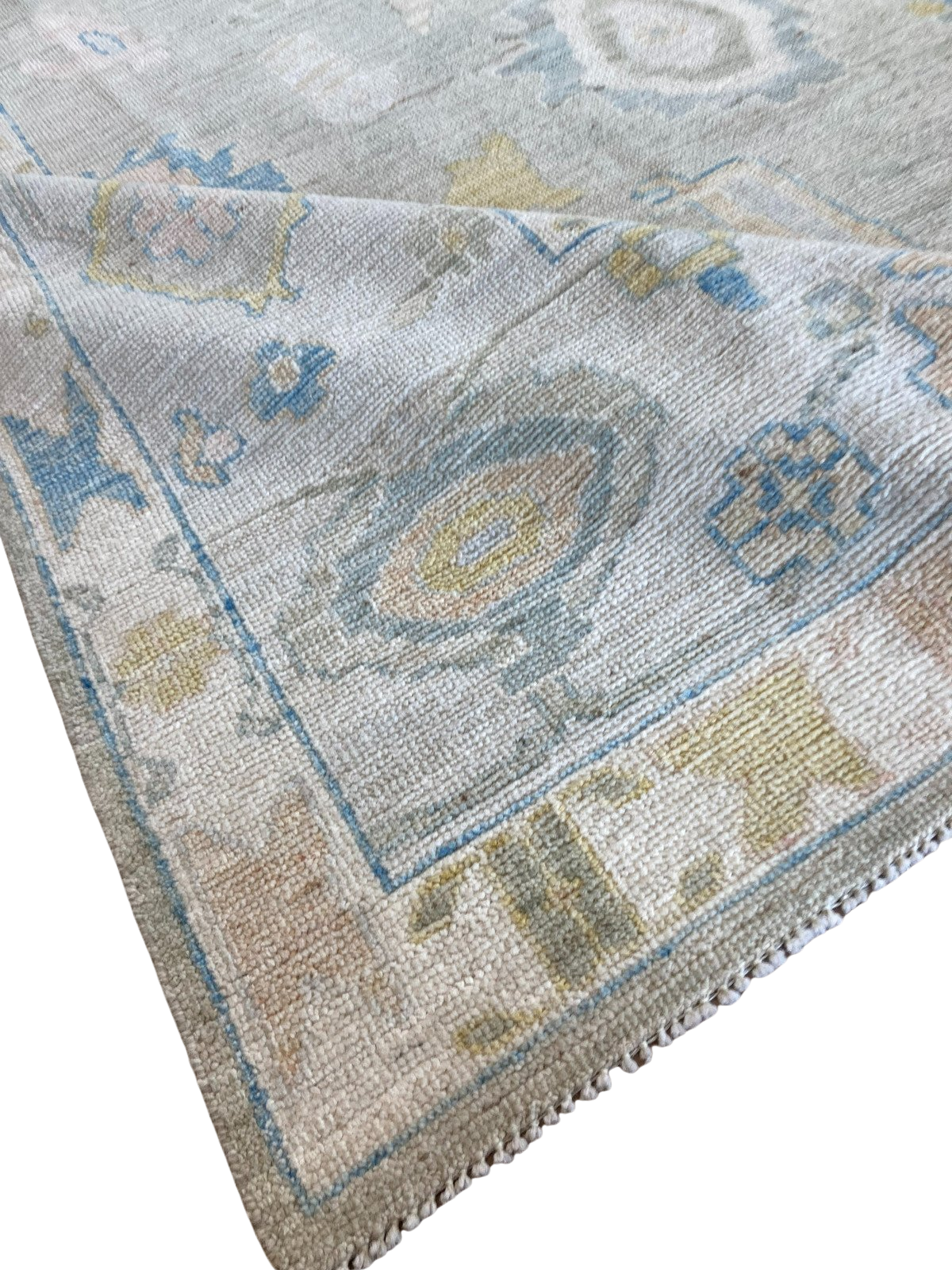 A rug with a pattern on it is sitting on a white surface.