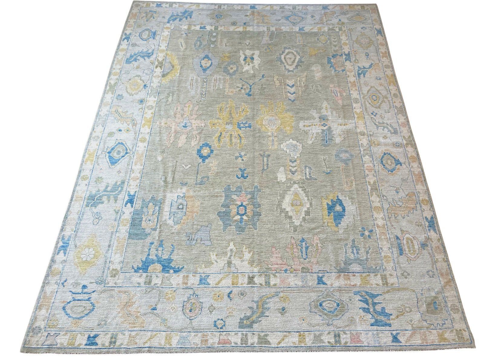 A rug with a pattern on it is sitting on a white surface.
