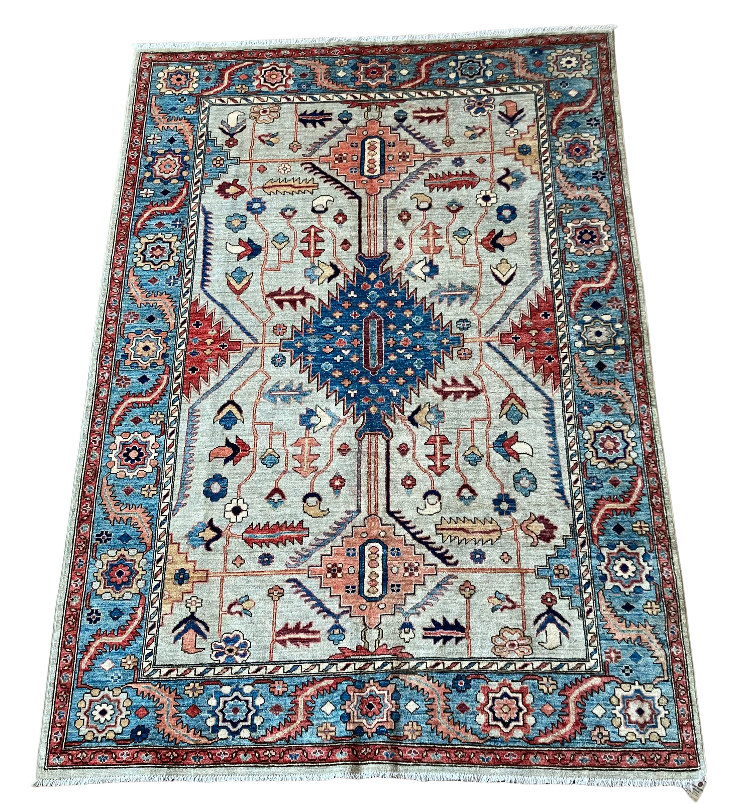 A rug with a pattern on it is sitting on a white surface.