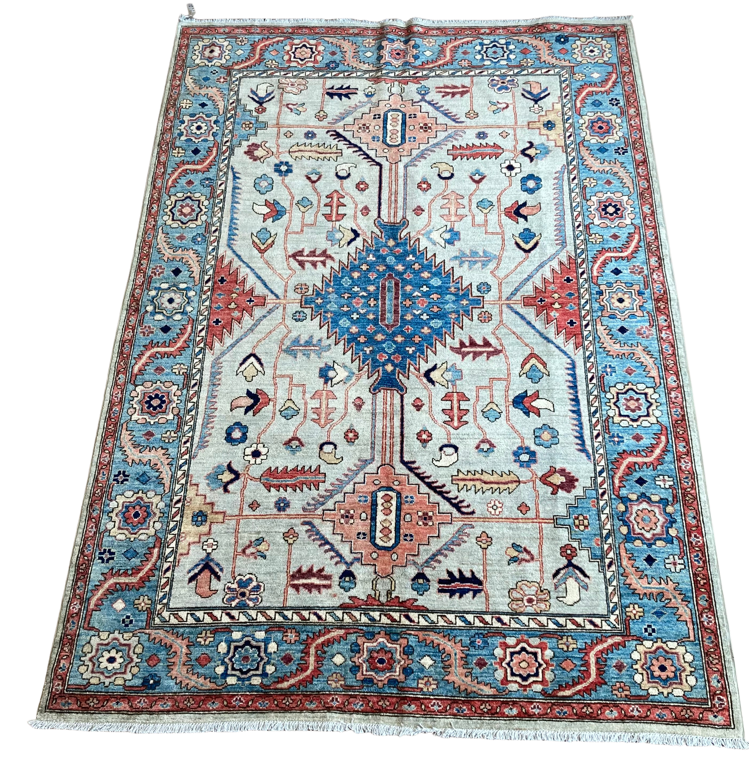 A rug with a pattern on it is sitting on a white surface.