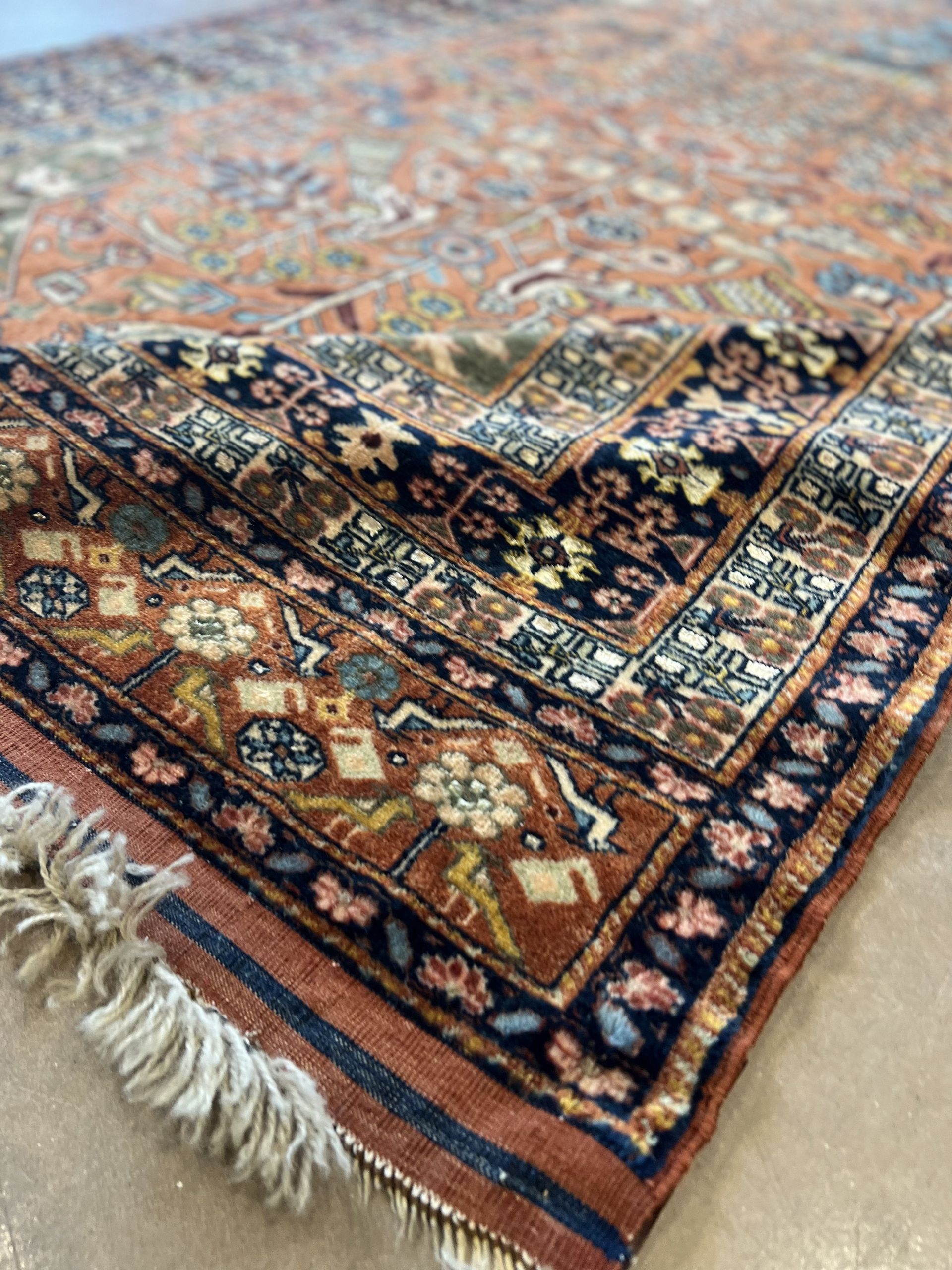 A close up of a rug with a floral pattern on it.