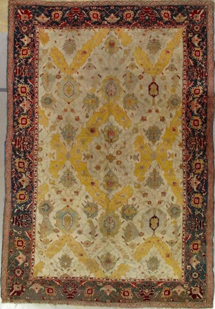 A rug with a yellow and red border is sitting on a table.