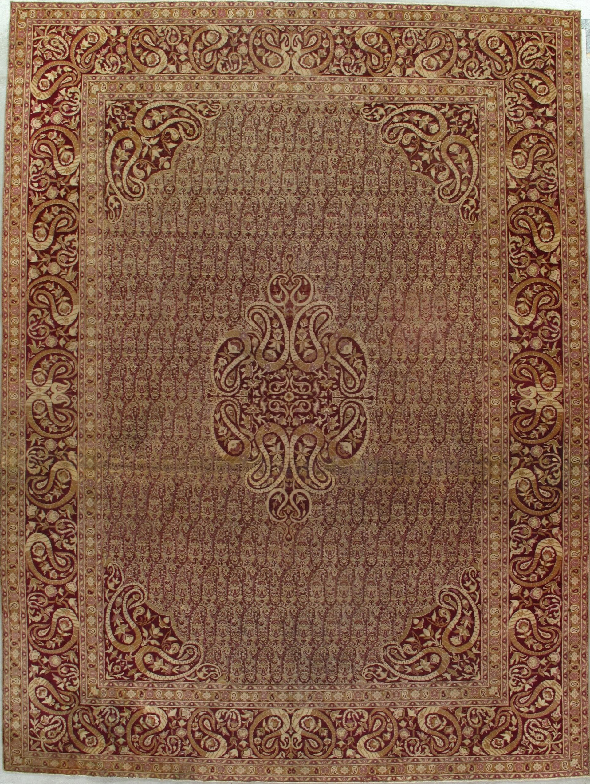 A brown rug with a pattern on it is hanging on a wall.