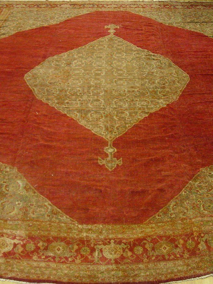 A large rug with a red diamond in the middle