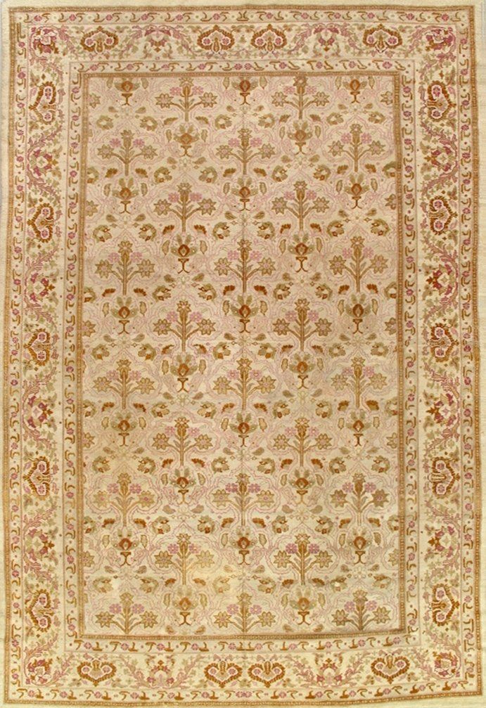 A rug with a floral pattern on it is on a white surface.