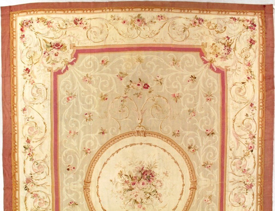 A rug with flowers and swirls on it