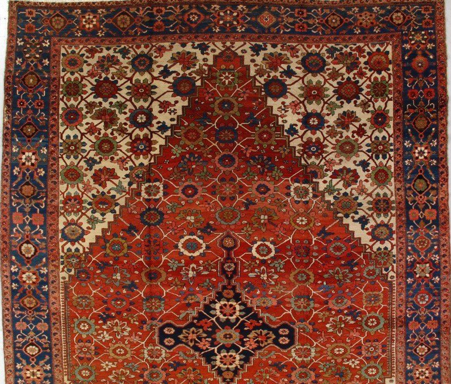 A red rug with a blue border and a floral pattern