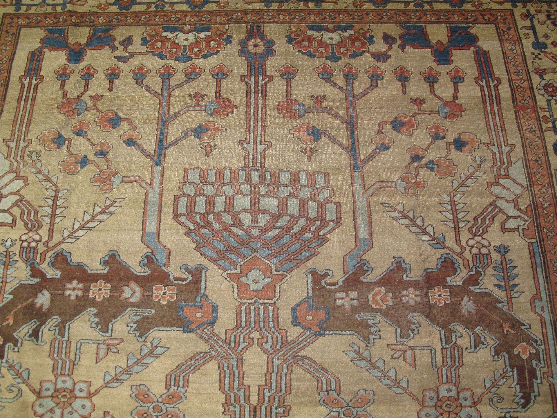 A rug with a tree and birds on it