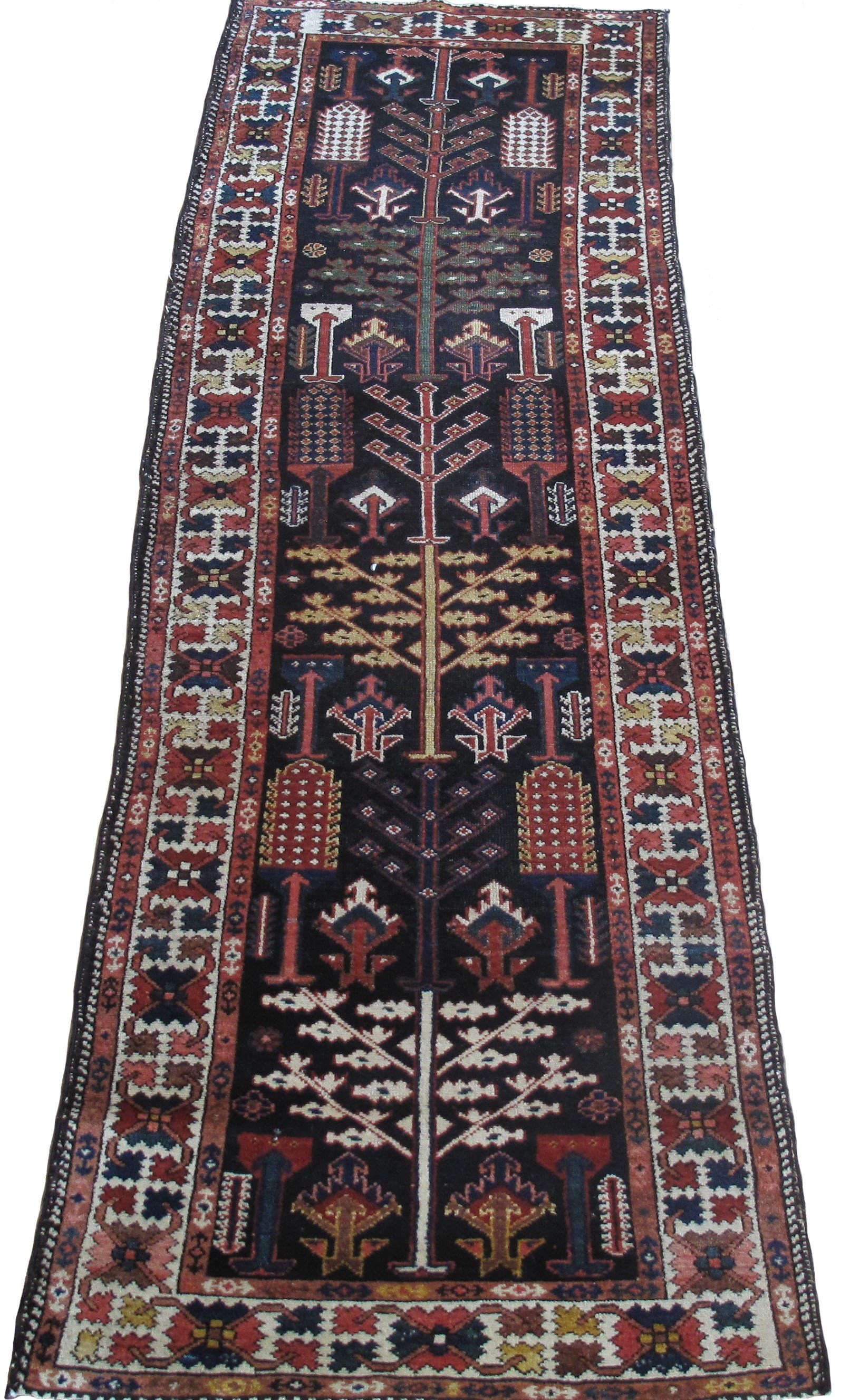 A colorful rug with a tree design and a few buildings on it