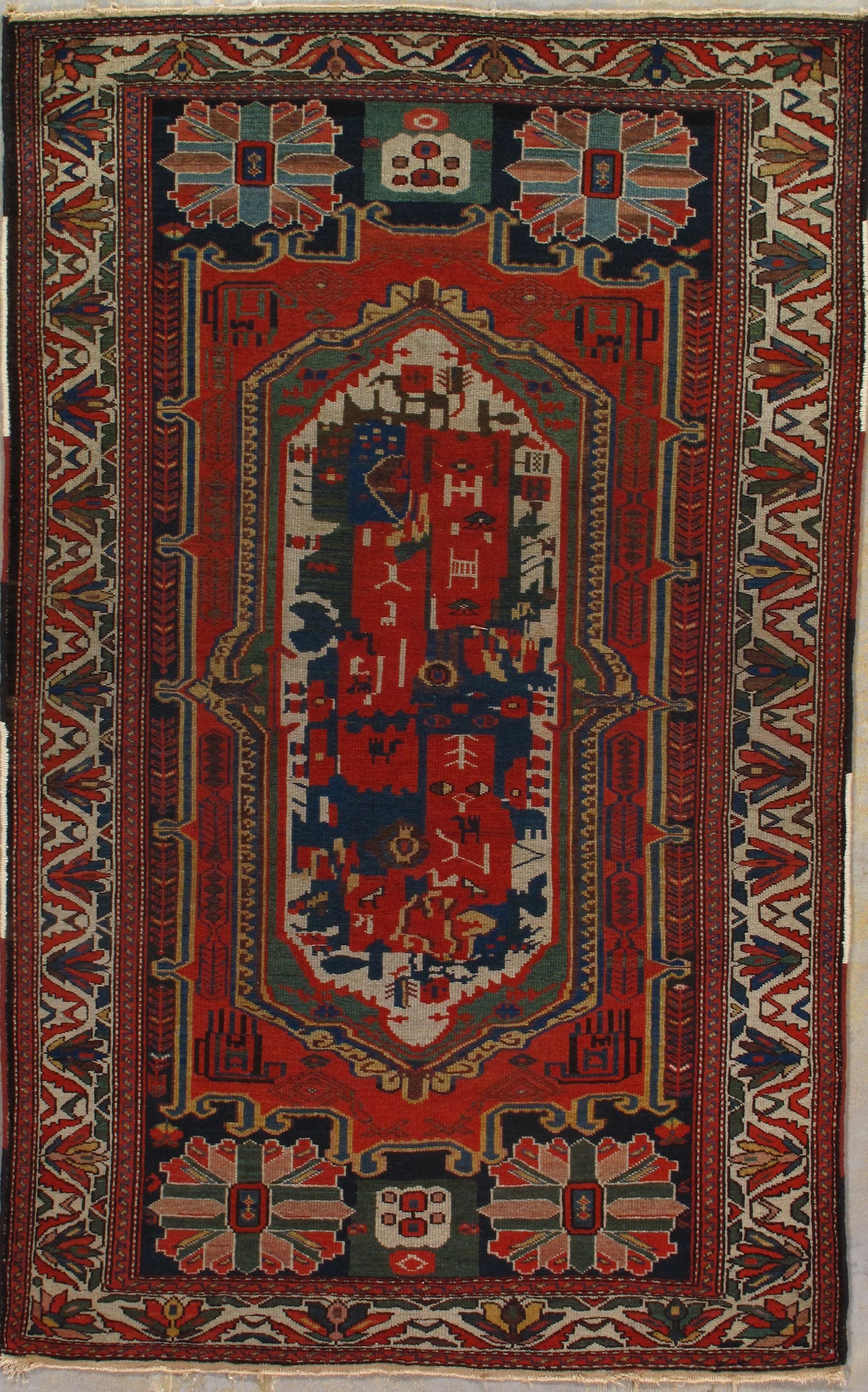 A red rug with a pattern on it is hanging on a wall.