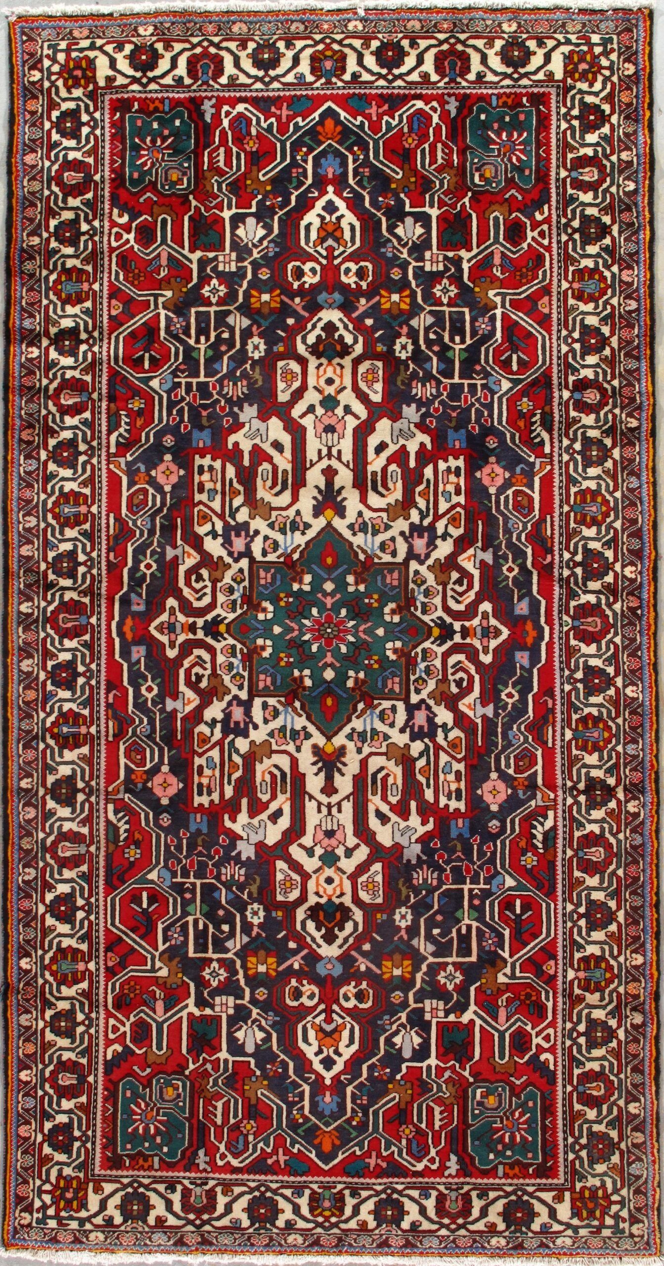 A red and blue rug with a floral pattern on it.
