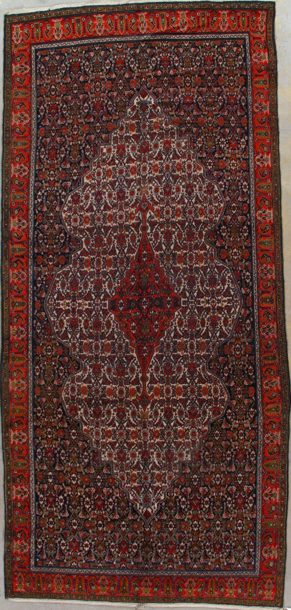 A rug with a pattern on it is hanging on a wall.