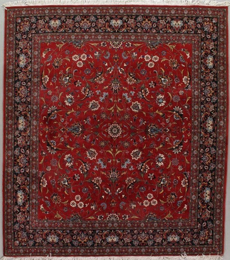 A red rug with a floral pattern on it