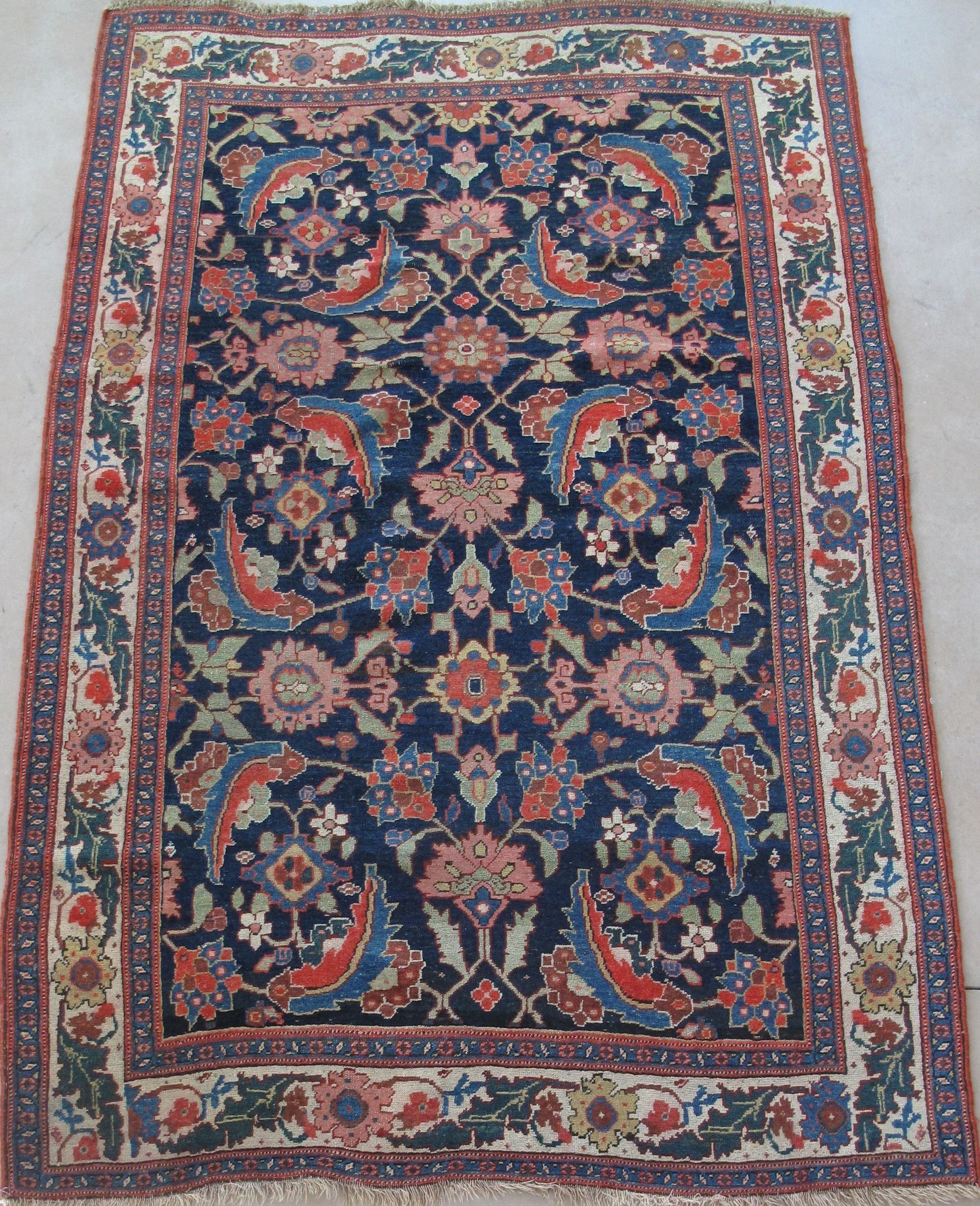 A rug with a blue and red floral pattern on it
