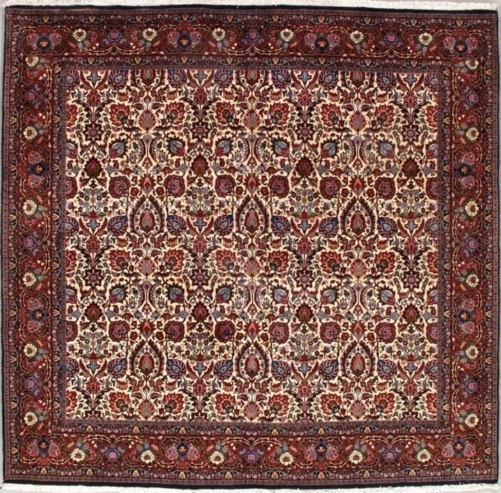 Square rug with intricate floral patterns in cream, red, and purple hues, bordered by a dark red band.