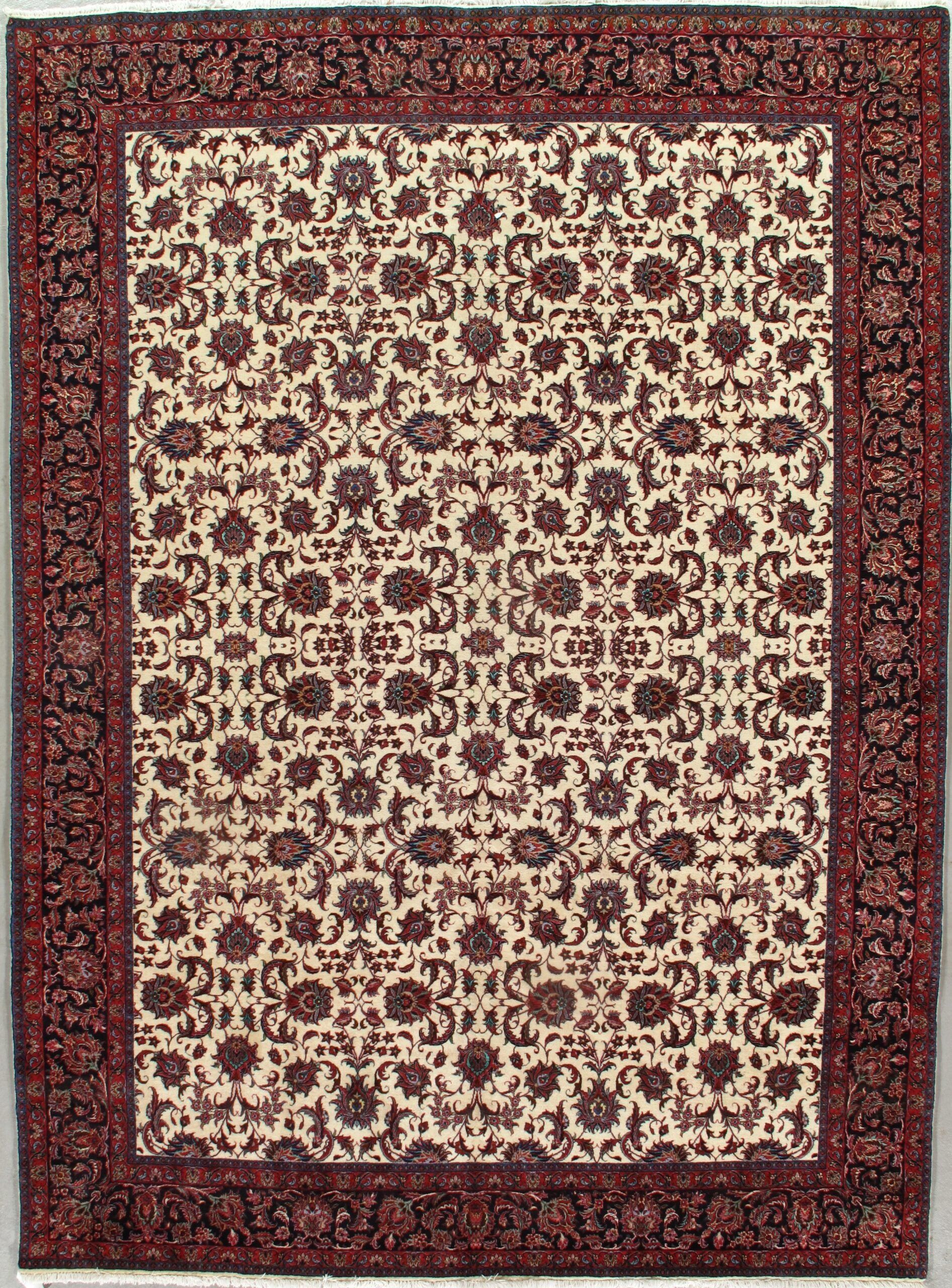 A rug with a floral pattern and a red border