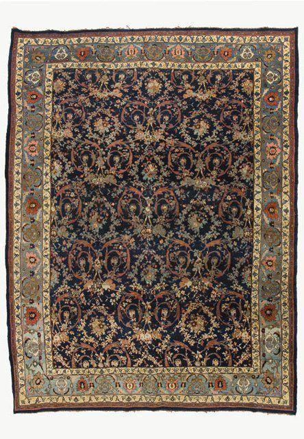 A rug with a floral pattern on it is on a white background.