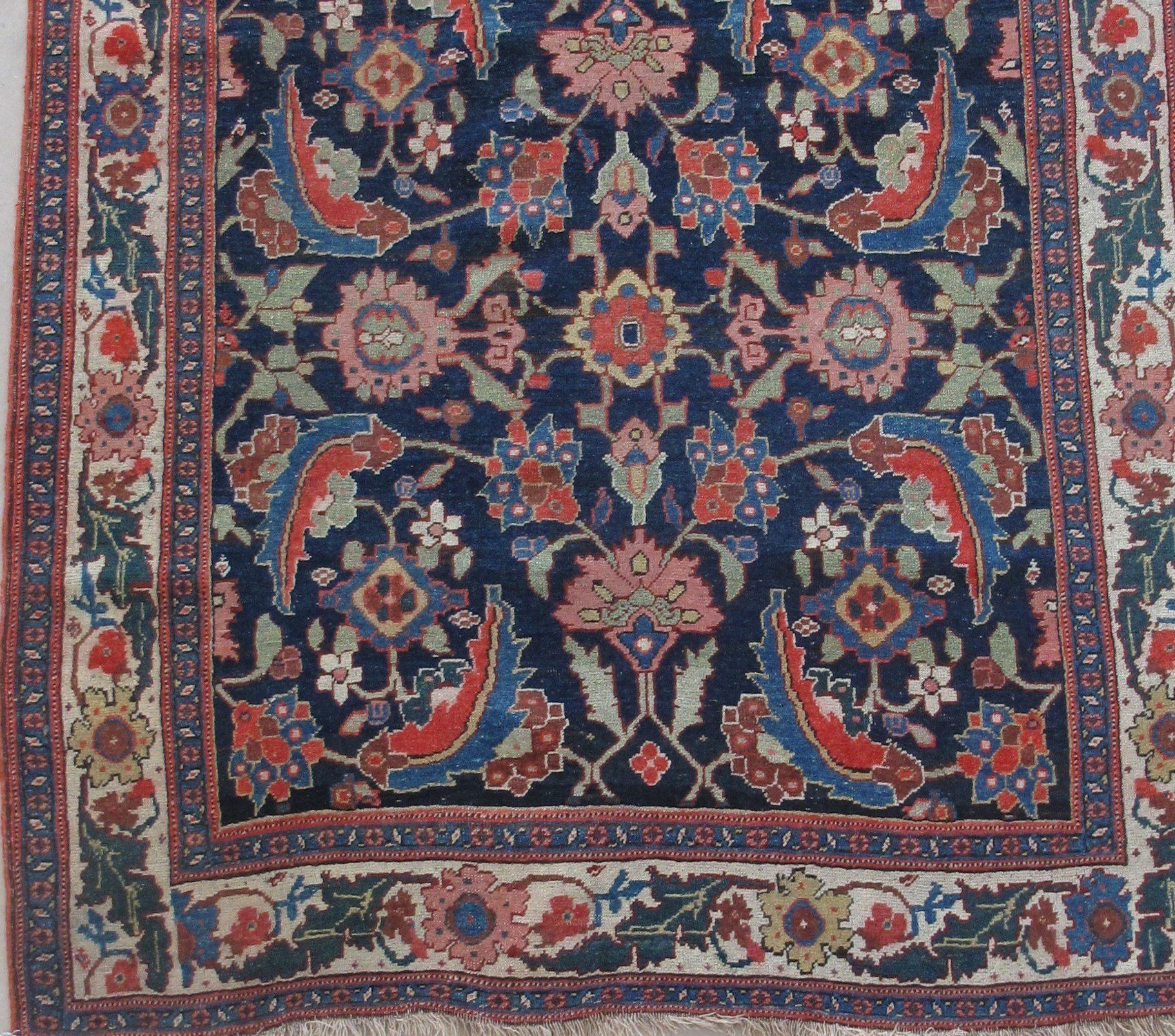 A rug with a blue and red floral pattern on it