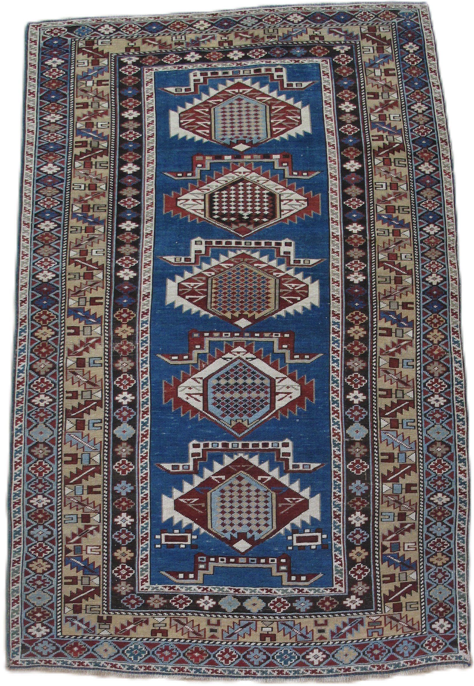 A blue and brown rug with a geometric pattern on it