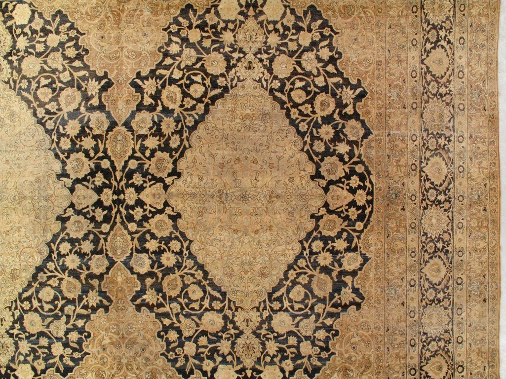 A close up of a rug with a circular pattern on it.