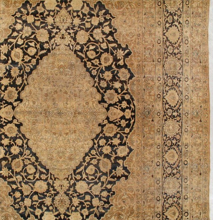 A close up of a rug with a circular pattern on it.